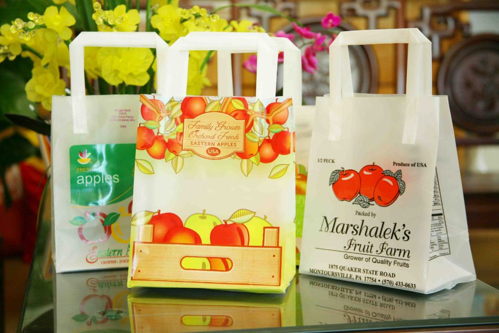 Custom printed plastic bags with soft loop handles for a produce and farm business